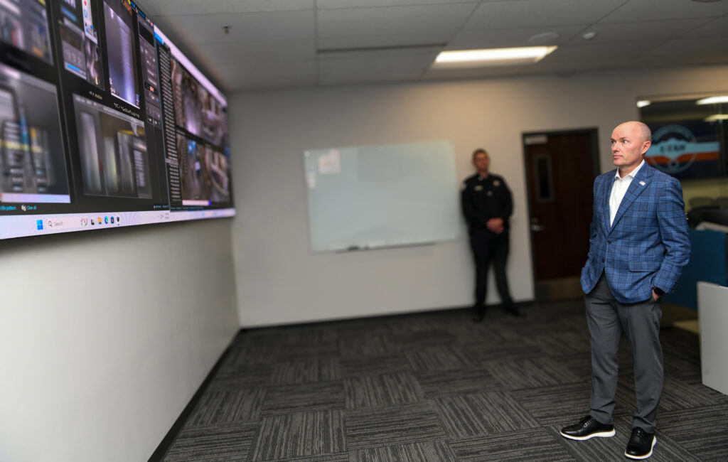 Image of Gov. Spencer Cox looking at the massive monitor at the UDC's IRIS Center.