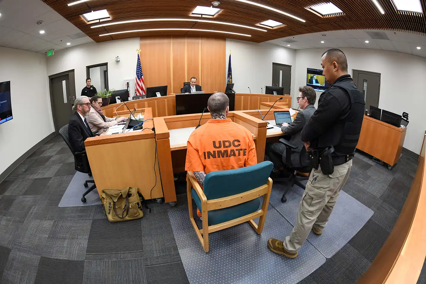 Image of incarcerated person in court with attorney