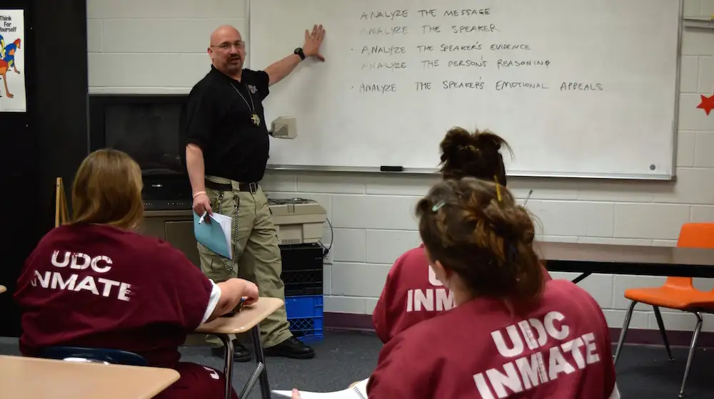 Correctional officer teaching female incarcerated individuals